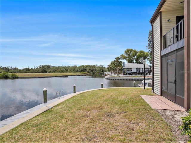 dock area featuring a yard and a water view
