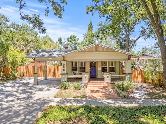 906 E Broad St, Tampa, FL 33604 - bungalow-style home featuring a porch, concrete driveway, a chimney, and an attached carport