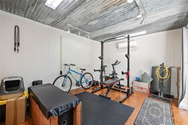 906 E Broad St, Tampa, FL 33604 - exercise area featuring an AC wall unit, a garage, and rail lighting