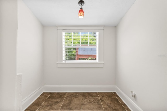906 E Broad St, Tampa, FL 33604 - spare room featuring baseboards and dark tile patterned floors