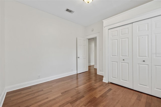 906 E Broad St, Tampa, FL 33604 - unfurnished bedroom featuring wood finished floors and a closet