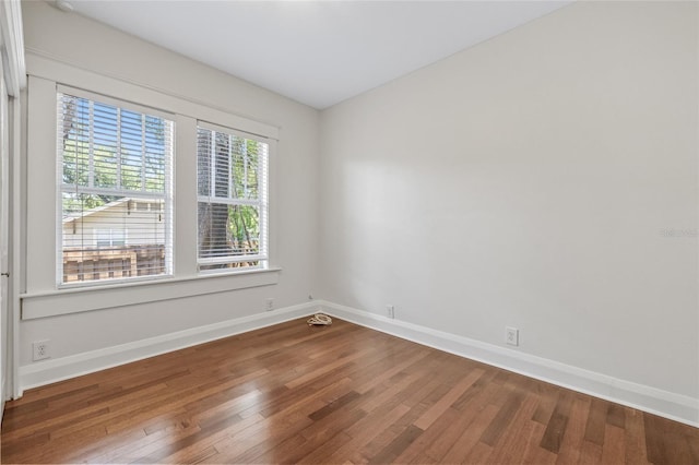 906 E Broad St, Tampa, FL 33604 - empty room with wood finished floors and baseboards