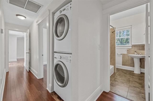 906 E Broad St, Tampa, FL 33604 - laundry area featuring stacked washer / drying machine and dark wood finished floors