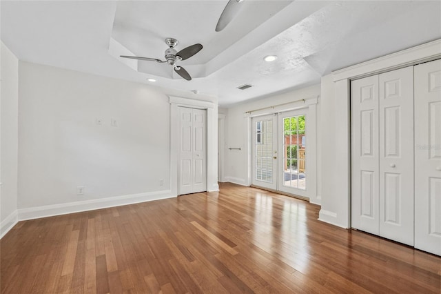 906 E Broad St, Tampa, FL 33604 - unfurnished bedroom with access to exterior, wood-type flooring, recessed lighting, a ceiling fan, and a raised ceiling
