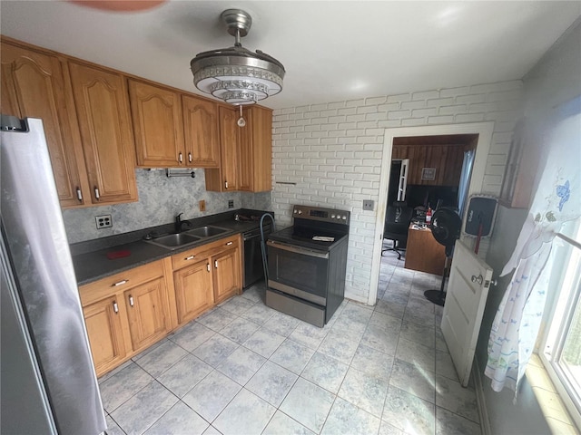 2435 37th Ave N, Saint Petersburg, FL 33713 - kitchen with appliances with stainless steel finishes, a sink, dark countertops, and brown cabinets