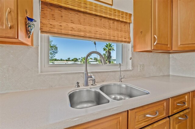 3021 Alton Dr, St Pete Beach, FL 33706 - kitchen with a sink, light countertops, decorative backsplash, and healthy amount of natural light