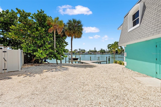 3021 Alton Dr, St Pete Beach, FL 33706 - view of yard with a dock and a water view