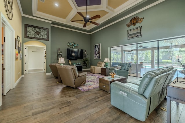 living room featuring a high ceiling, ornamental molding, coffered ceiling, and ceiling fan