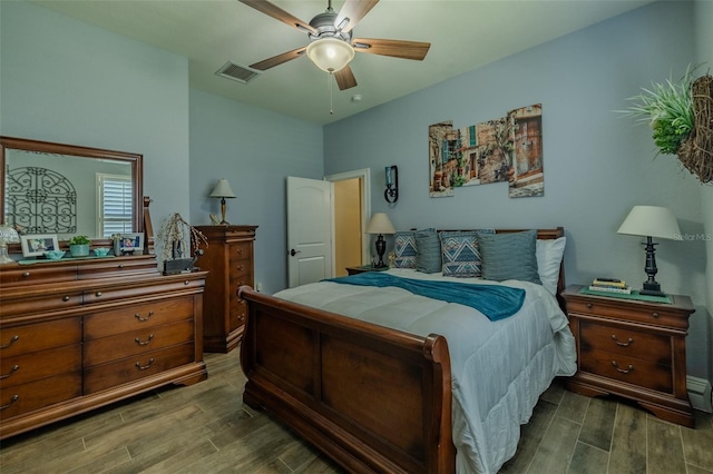 bedroom with a ceiling fan, visible vents, and wood finished floors