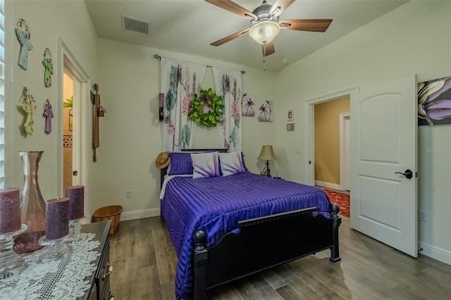 bedroom with ceiling fan, baseboards, visible vents, and wood finished floors