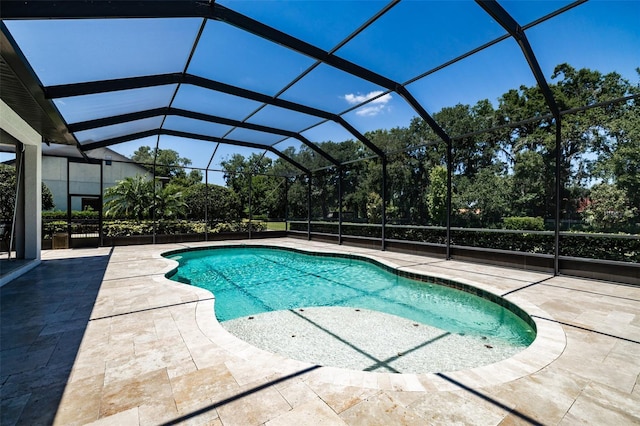pool featuring a patio and glass enclosure