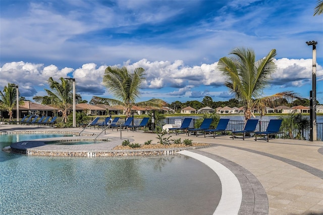 20423 Symphony Pl, Venice, FL 34293 - community pool featuring a community hot tub, a patio, and a residential view