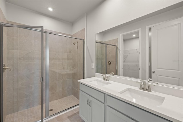 20423 Symphony Pl, Venice, FL 34293 - bathroom with a shower stall, recessed lighting, double vanity, and a spacious closet