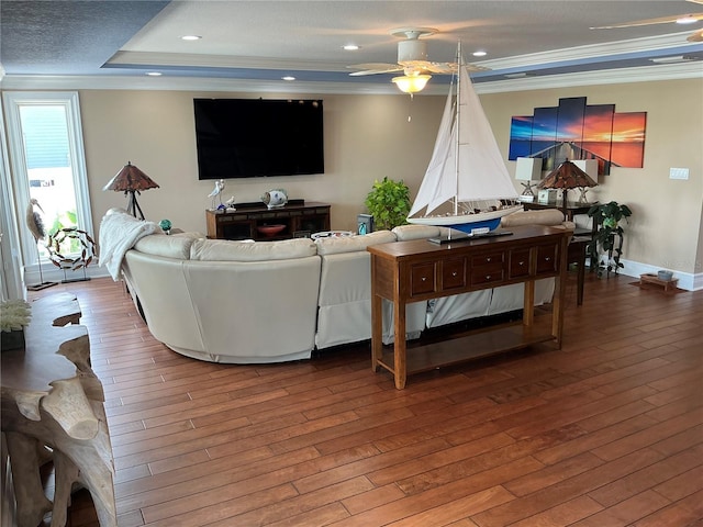 324 6th Ave, Indian Rocks Beach, FL 33785 - living room with crown molding, ceiling fan, a tray ceiling, and hardwood / wood-style flooring