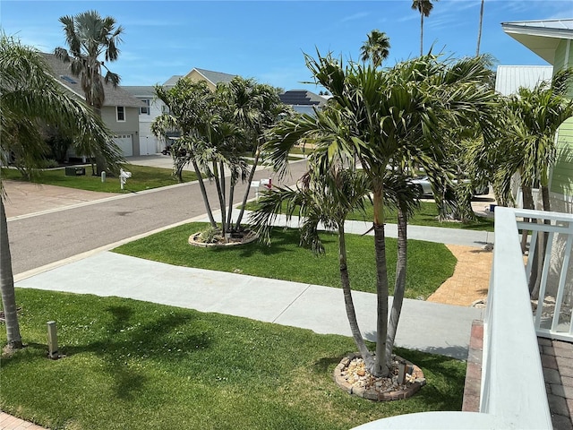 324 6th Ave, Indian Rocks Beach, FL 33785 - view of property's community featuring a lawn, an attached garage, and driveway