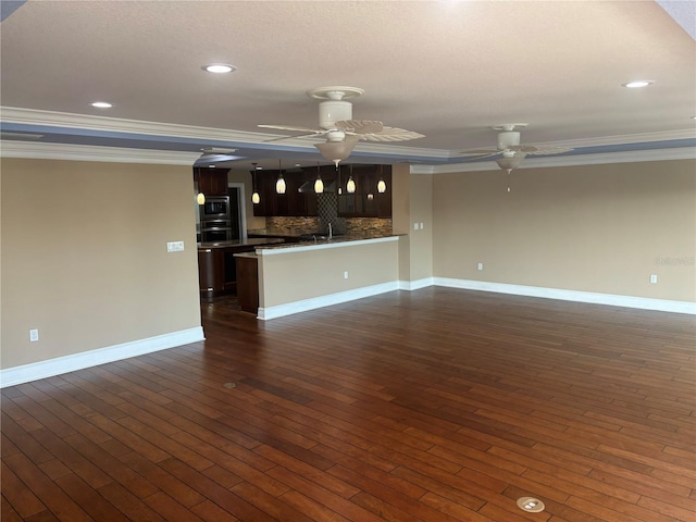 324 6th Ave, Indian Rocks Beach, FL 33785 - unfurnished living room featuring crown molding, baseboards, ceiling fan, recessed lighting, and dark wood-type flooring