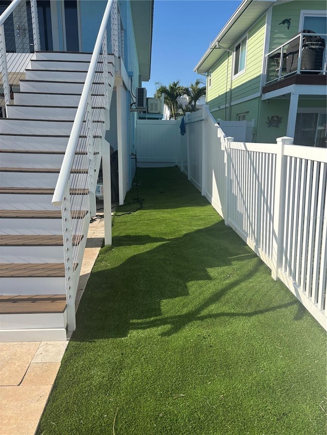 324 6th Ave, Indian Rocks Beach, FL 33785 - view of yard featuring a fenced backyard and stairway