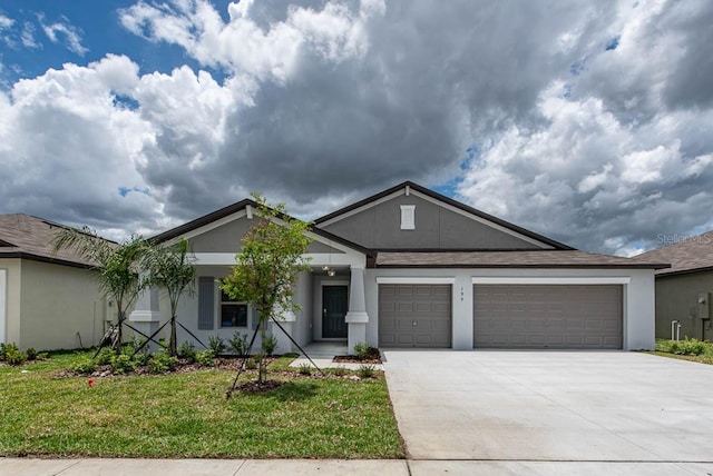 ranch-style house featuring concrete driveway, an attached garage, a front lawn, and stucco siding