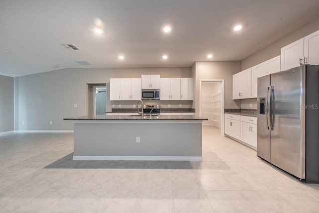 kitchen featuring appliances with stainless steel finishes, white cabinetry, and visible vents
