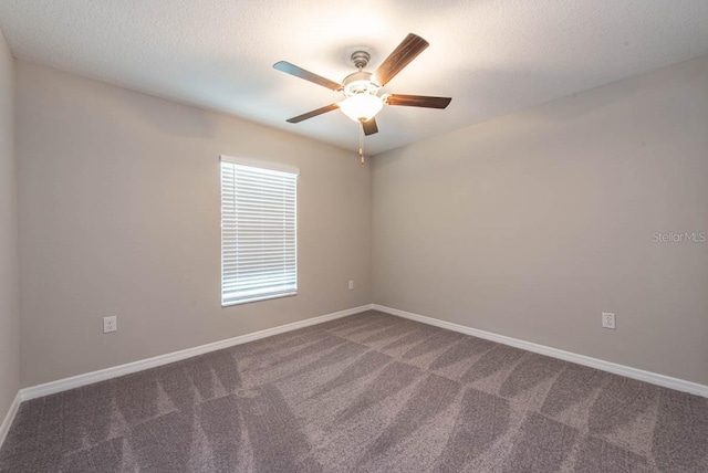 unfurnished room featuring baseboards, a ceiling fan, and carpet