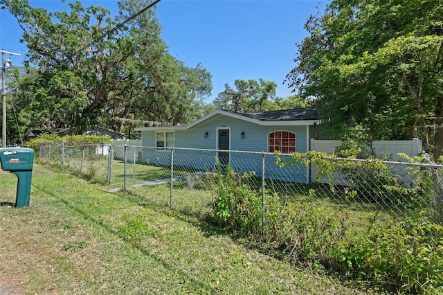 view of front of house with fence private yard and a front lawn