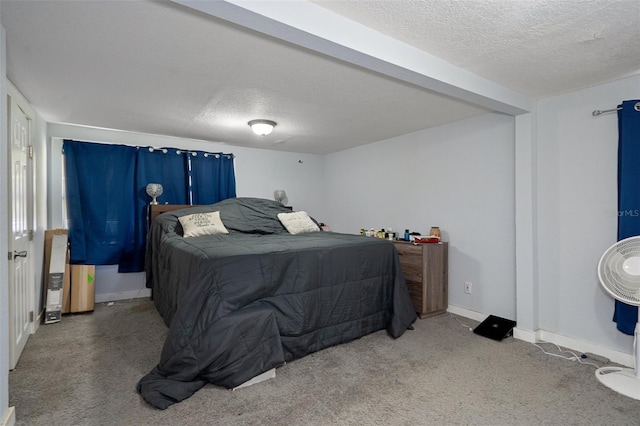 carpeted bedroom featuring baseboards and a textured ceiling