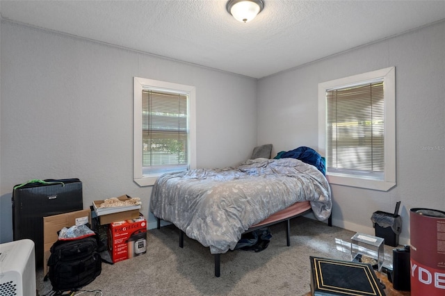 carpeted bedroom featuring a textured ceiling