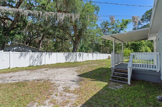 view of yard featuring fence and a deck