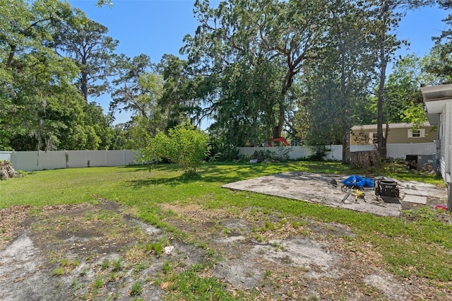 view of yard with a fenced backyard, an outdoor fire pit, and a patio area