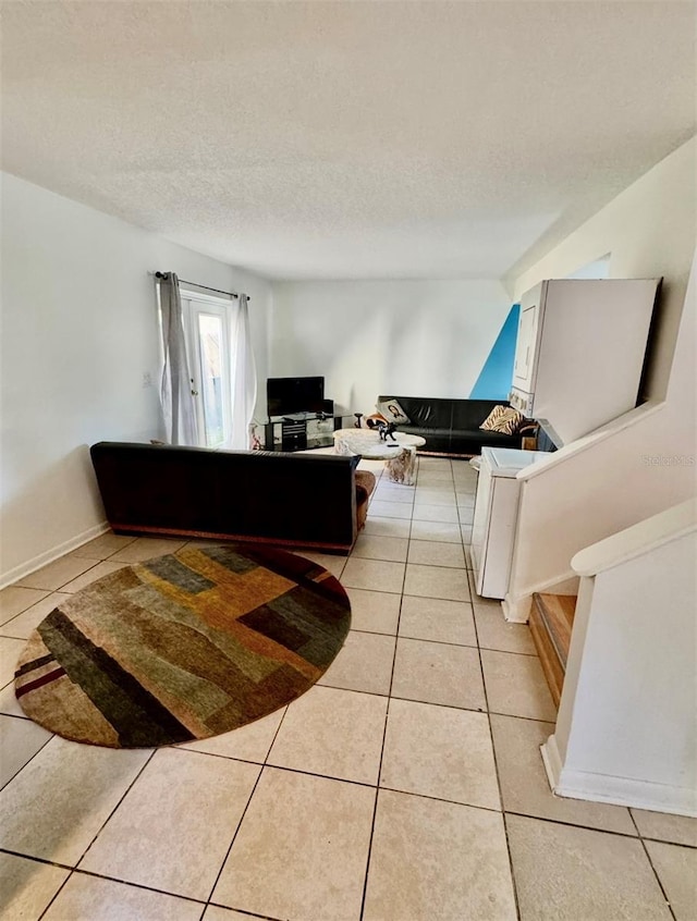 living room featuring light tile patterned flooring and a textured ceiling