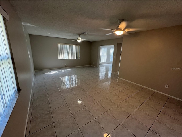 2826 Rampart Cir, Clearwater, FL 33761 - spare room with a ceiling fan, a textured ceiling, baseboards, light tile patterned floors, and visible vents