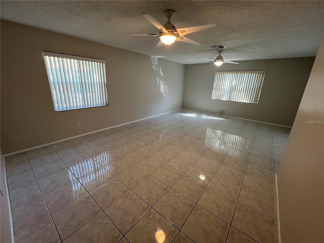 2826 Rampart Cir, Clearwater, FL 33761 - empty room featuring a ceiling fan, tile patterned floors, a textured ceiling, visible vents, and baseboards