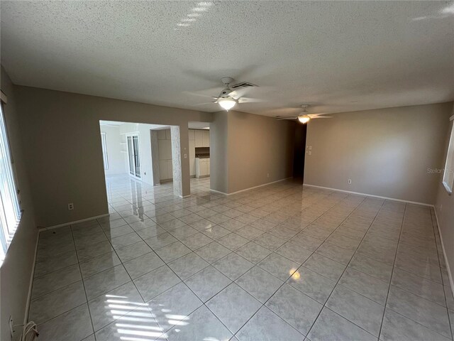 2826 Rampart Cir, Clearwater, FL 33761 - unfurnished room with a textured ceiling, light tile patterned floors, baseboards, visible vents, and ceiling fan