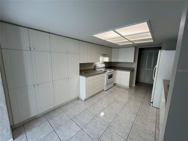 2826 Rampart Cir, Clearwater, FL 33761 - kitchen featuring under cabinet range hood, white appliances, light tile patterned flooring, white cabinetry, and dark countertops