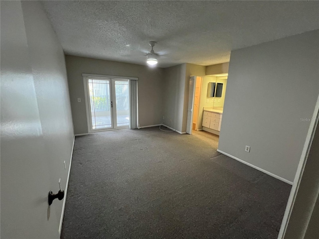 2826 Rampart Cir, Clearwater, FL 33761 - carpeted spare room featuring a textured ceiling, baseboards, and a ceiling fan