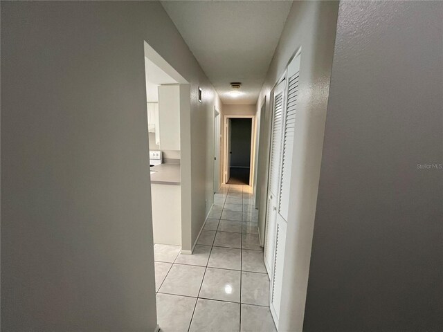 2826 Rampart Cir, Clearwater, FL 33761 - hallway featuring light tile patterned flooring