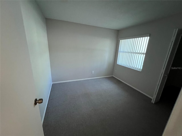 2826 Rampart Cir, Clearwater, FL 33761 - empty room with baseboards and dark carpet