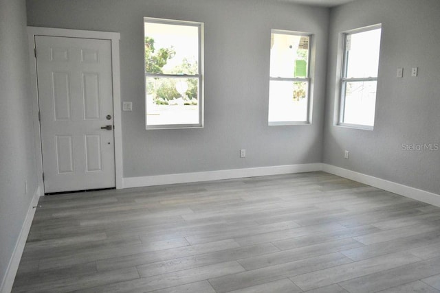 foyer entrance featuring wood finished floors and baseboards