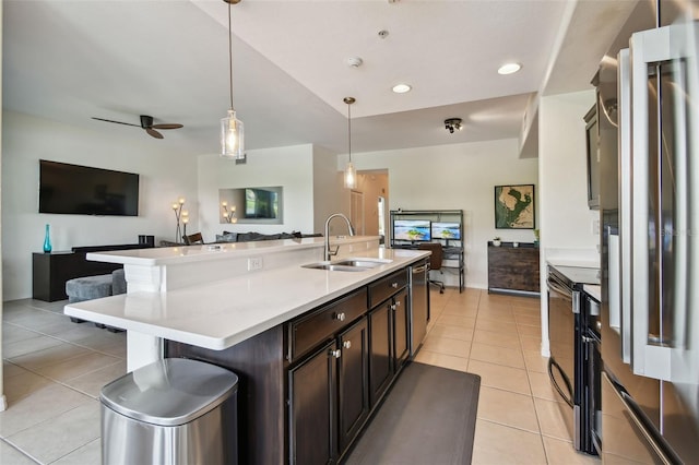 1003 Fairwaycove Ln Unit 103, Bradenton, FL 34212 - kitchen with appliances with stainless steel finishes, open floor plan, a sink, light tile patterned flooring, and recessed lighting