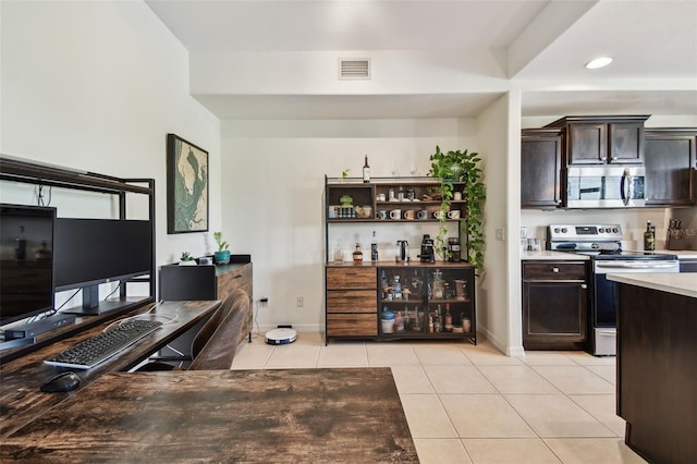 1003 Fairwaycove Ln Unit 103, Bradenton, FL 34212 - bar area with appliances with stainless steel finishes, light tile patterned floors, and baseboards
