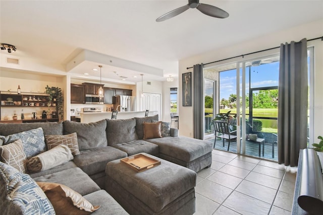 1003 Fairwaycove Ln Unit 103, Bradenton, FL 34212 - living room featuring light tile patterned flooring and a ceiling fan