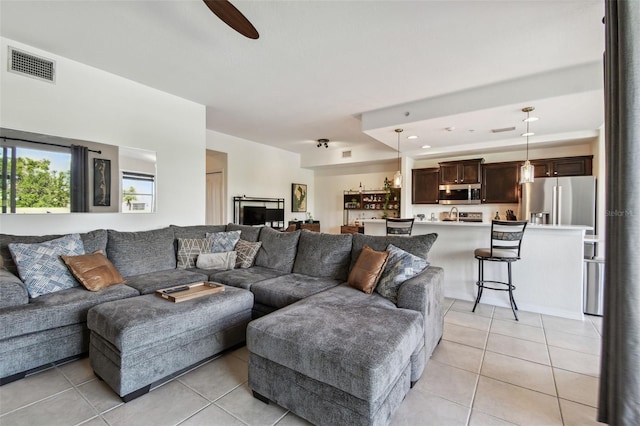 1003 Fairwaycove Ln Unit 103, Bradenton, FL 34212 - living area with light tile patterned flooring and a ceiling fan