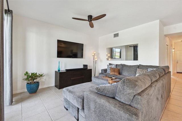 1003 Fairwaycove Ln Unit 103, Bradenton, FL 34212 - living area featuring light tile patterned flooring, ceiling fan, and baseboards
