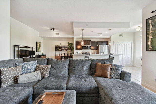 1003 Fairwaycove Ln Unit 103, Bradenton, FL 34212 - living area with light tile patterned floors and baseboards