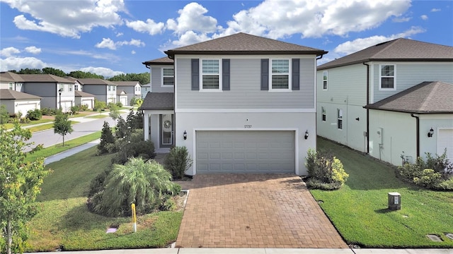 17737 Everlong Dr, Land O Lakes, FL 34638 - traditional home with a garage, a front yard, decorative driveway, a shingled roof, and a residential view