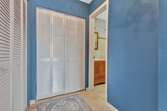 hall with light tile patterned floors