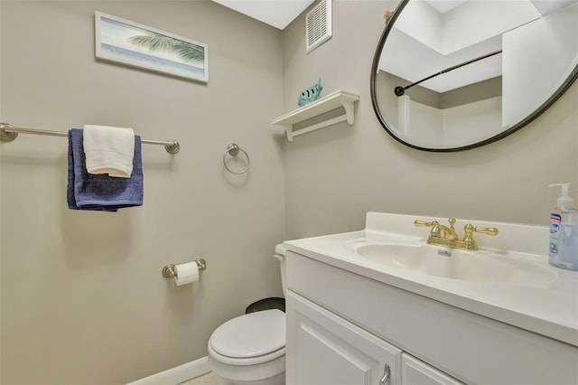 bathroom with visible vents, baseboards, toilet, and vanity
