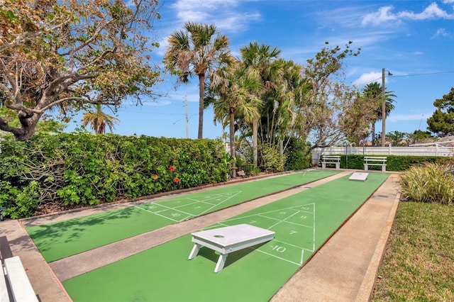 surrounding community with fence and shuffleboard