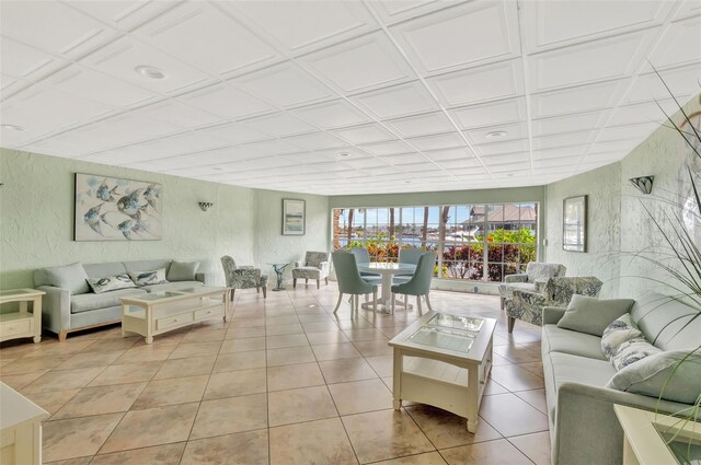 living area with a textured wall and light tile patterned floors