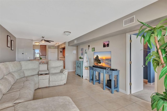 living area with a ceiling fan, baseboards, visible vents, and light tile patterned floors